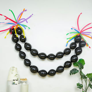Black balloon garland with colorful accents for festive decorations.