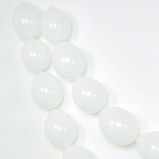 White balloons arranged in a decorative garland on a white background.