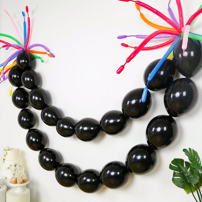 Black balloon garland with colorful accents for party decoration.