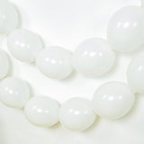 White balloons strung together on a plain background