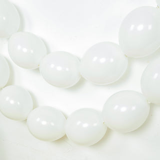 White balloons strung together on a plain background