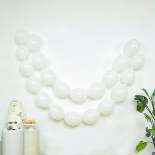 White balloons arranged in a decorative arch against a light background.