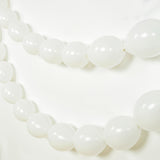 White balloon garland on a plain white background