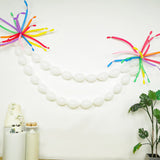 Colorful balloon garland decoration with white balloons and vibrant accents.