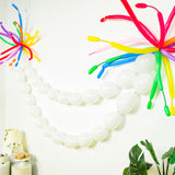 Colorful balloon decorations on a wall for a festive celebration.