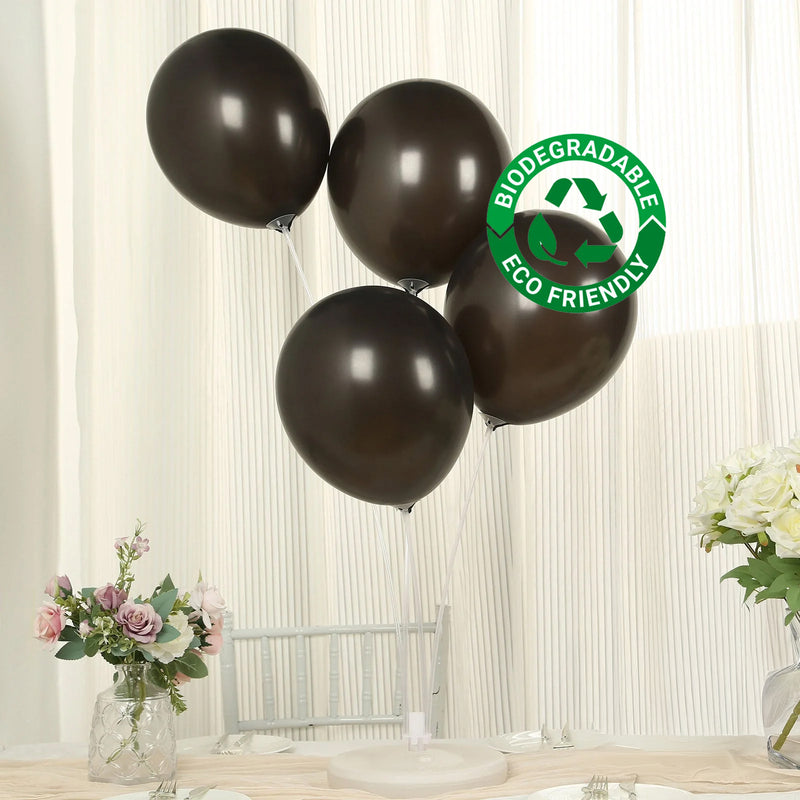 Black biodegradable balloons at a decorated table setting