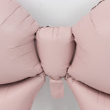 Pink balloon bow decoration on a plain background