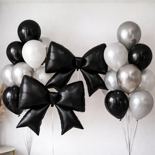Black and silver balloon bouquet with large star-shaped bows.