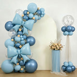 Blue balloon arch with decorative bows and floral accents for events.