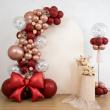 Elegant balloon arch with floral accents and decorations for events or celebrations.