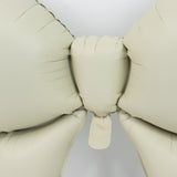 Beige inflatable bow balloon on a white background