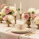 Elegant floral-themed tea box on a beautifully set table with roses and candles.