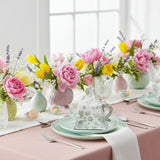 Decorative teapot with floral design on a beautifully arranged spring table setting.