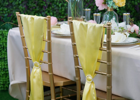 Gold chiavari chairs with yellow sashes