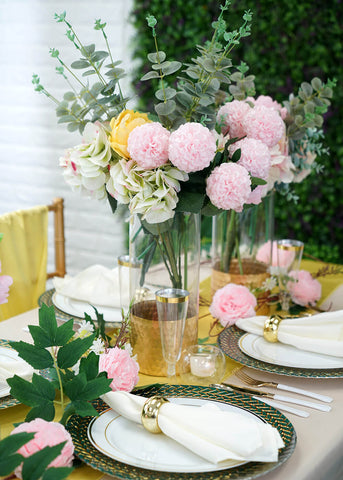 Tall floral centerpiece in a gold vase