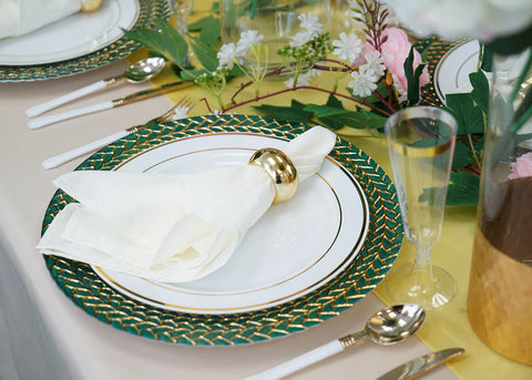 White plate with folded napkin and gold napkin ring