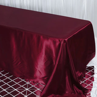 Enhance Your Table Decor with the Burgundy Satin Seamless Rectangular Tablecloth