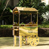 Gold vintage cart on wheels in a garden setting.