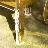 Gold and white table leg design on grass
