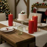 Christmas dining table with red candles, cake, and festive decor.