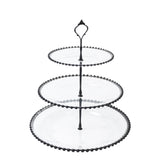 Three-tiered glass serving stand with black beaded edge and ornate handle #whtbkgd