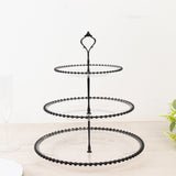 Three-tier black serving stand with glass plates for elegant displays.