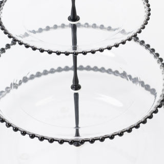 Two-tiered glass serving stand with decorative bead detail.