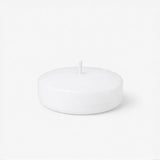 White round candle on a plain background