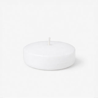 White round candle on a plain background