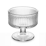 Clear glass pedestal dessert cup with ribbed sides on white background