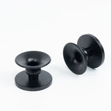 Black decorative candle holders set on a plain background