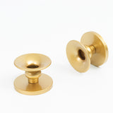 Gold decorative knobs on a plain white background