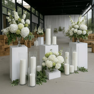 White floral arrangements and candles in a modern event space.