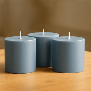 Blue pillar candles on a wooden table.