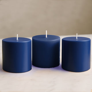 Navy blue pillar candles in a studio-style shot