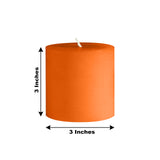 Orange pillar candle, 3 inches in height and width.