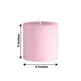 Pink pillar candle, 3 inches tall and 3 inches wide.