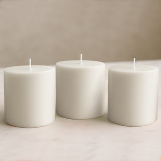 Set of three white pillar candles in various heights