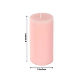 Pink pillar candle, 6 inches tall and 3 inches wide.