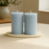 Blue pillar candles on a cream tray in a serene home setting.