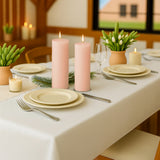 Elegant dining table set with pink candles and spring decor.