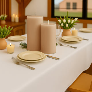 Elegant table setting with candles and tulips in a cozy dining space.