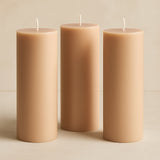 Set of three beige pillar candles in varying heights