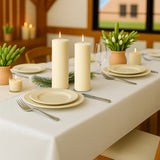 Elegant dining table set with candles and plates for a cozy gathering.