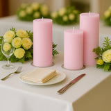 Pink candles and floral arrangement on a beautifully set dining table.