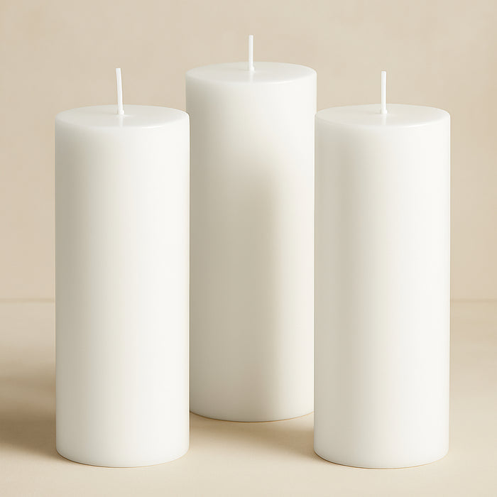 Set of three elegant white pillar candles in varying heights.