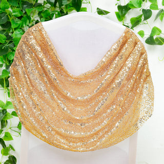 Gold sequin scarf draped elegantly on a white chair against greenery background.