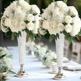 Elegant white floral arrangements in crystal vases for wedding decor.