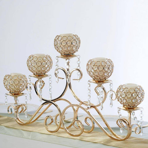 Gold candelabra centerpiece on a white table