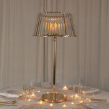Elegant gold table lamp with a glass shade on a dining table.